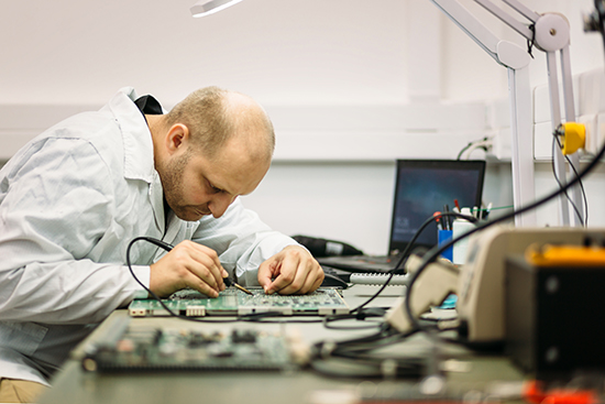 technician fixing motherboard